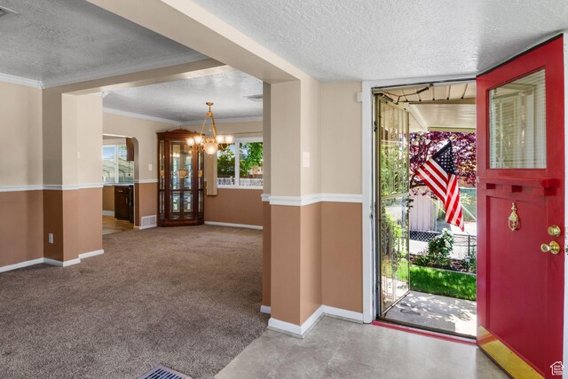 1979 S 600 E, Salt Lake City, UT 84105 - foyer entrance with a textured ceiling, a chandelier, baseboards, ornamental molding, and carpet flooring