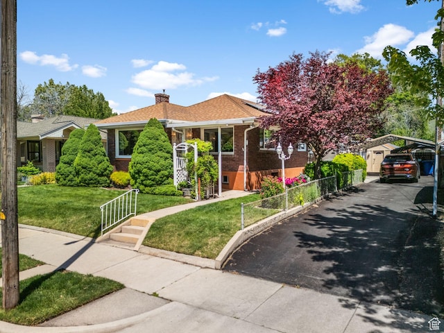 1979 S 600 E, Salt Lake City, UT 84105 - view of front of home with brick siding, a chimney, a detached carport, roof mounted solar panels, and asphalt driveway