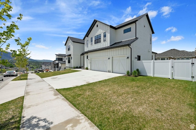 7862 S Danish Pine Ln, Salt Lake City, UT 84121 - view of side of home with a garage, concrete driveway, a gate, board and batten siding, and a standing seam roof