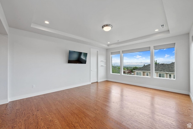 7862 S Danish Pine Ln, Salt Lake City, UT 84121 - empty room featuring a tray ceiling, wood finished floors, baseboards, and recessed lighting
