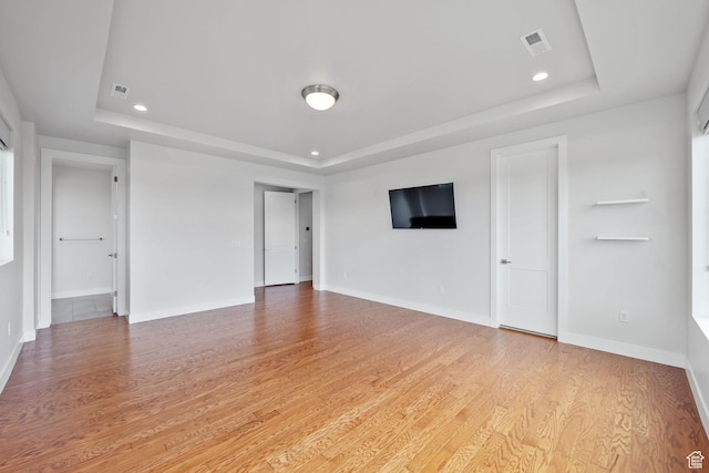 7862 S Danish Pine Ln, Salt Lake City, UT 84121 - unfurnished living room featuring a raised ceiling, light wood-style flooring, baseboards, and recessed lighting