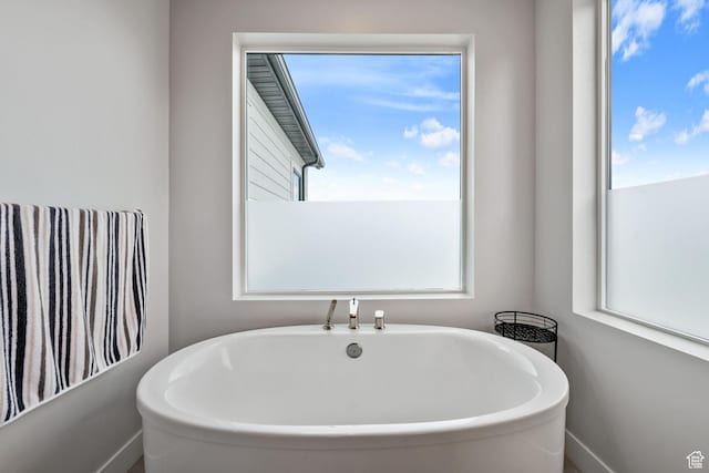 7862 S Danish Pine Ln, Salt Lake City, UT 84121 - full bathroom featuring a freestanding bath and healthy amount of natural light