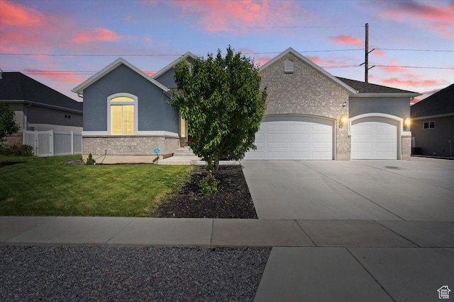 3352 N 200 W, Lehi, UT 84043 - view of front of house with a garage, driveway, brick siding, and stucco siding