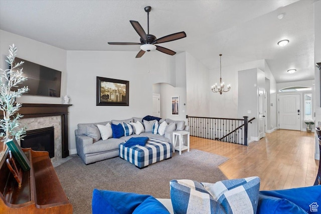 3352 N 200 W, Lehi, UT 84043 - living area featuring a ceiling fan, arched walkways, lofted ceiling, a high end fireplace, and a chandelier