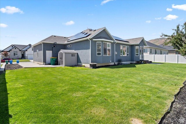 3352 N 200 W, Lehi, UT 84043 - rear view of property with roof mounted solar panels, stucco siding, and an attached garage