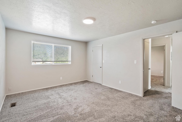 221 N Pingree Ave E, Ogden, UT 84404 - unfurnished bedroom with carpet floors, a textured ceiling, and baseboards