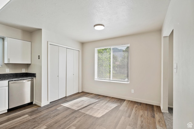 221 N Pingree Ave E, Ogden, UT 84404 - kitchen with dishwasher, white cabinetry, light wood-type flooring, baseboards, and a textured ceiling