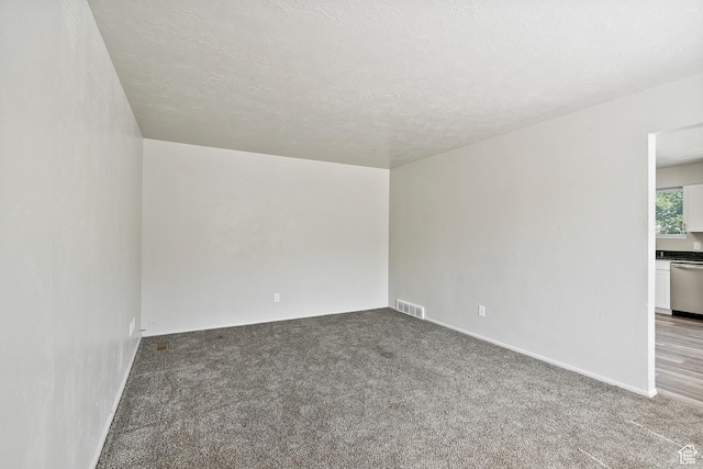 221 N Pingree Ave E, Ogden, UT 84404 - carpeted empty room with baseboards and a textured ceiling