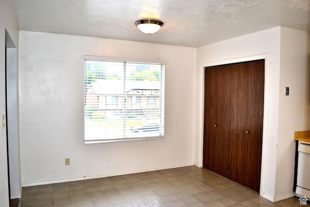 221 N Pingree Ave E, Ogden, UT 84404 - unfurnished bedroom featuring a closet and a textured ceiling