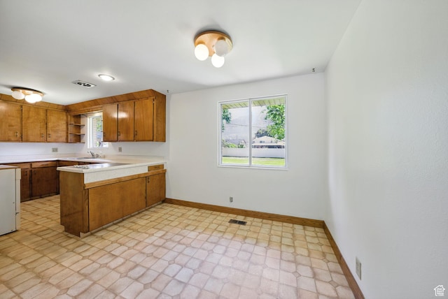 232 N 600 E, Orem, UT 84097 - kitchen with a sink, brown cabinetry, open shelves, baseboards, and light countertops