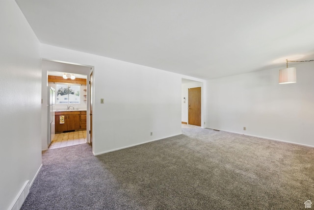 232 N 600 E, Orem, UT 84097 - spare room featuring light colored carpet, a sink, and baseboards