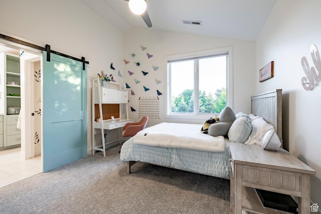 5972 S Ragsdale Dr, Murray, UT 84121 - bedroom with vaulted ceiling, a barn door, light carpet, ceiling fan, and connected bathroom