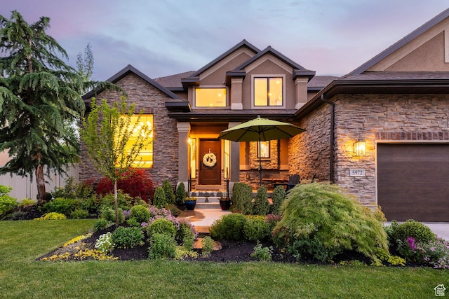 5972 S Ragsdale Dr, Murray, UT 84121 - view of front facade with stone siding, stucco siding, a lawn, and a garage