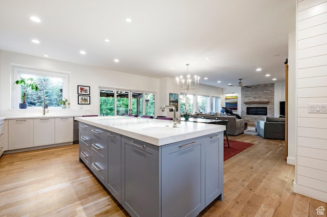 5972 S Ragsdale Dr, Murray, UT 84121 - kitchen featuring gray cabinets, a sink, recessed lighting, an island with sink, and light wood-style floors