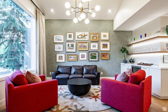 5972 S Ragsdale Dr, Murray, UT 84121 - living area with light wood-type flooring, a bar, and a chandelier