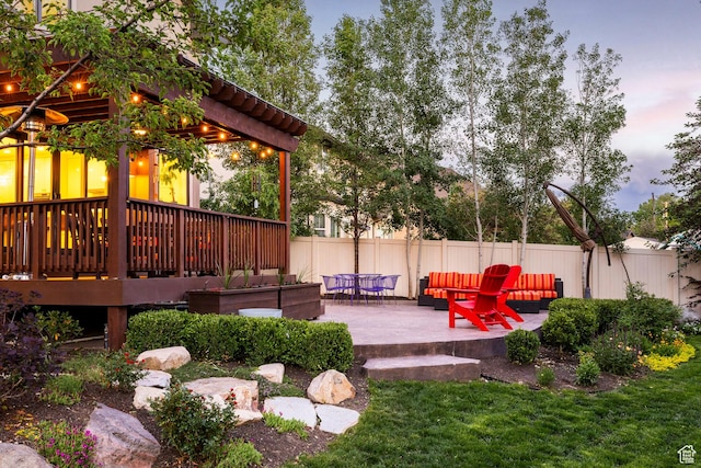 5972 S Ragsdale Dr, Murray, UT 84121 - yard at dusk with a wooden deck, a patio area, and an outdoor living space
