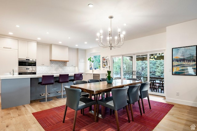 5972 S Ragsdale Dr, Murray, UT 84121 - dining area featuring a chandelier, light wood-style flooring, recessed lighting, and baseboards