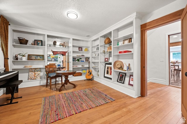 1503 S 300 E, Salt Lake City, UT 84115 - sitting room featuring a textured ceiling, wood finished floors, and built in features