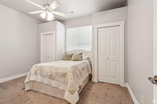603 S Temple Hill Cir E, Bountiful, UT 84010 - bedroom with light colored carpet, two closets, baseboards, and a ceiling fan