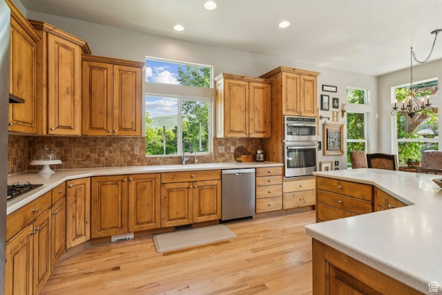 603 S Temple Hill Cir E, Bountiful, UT 84010 - kitchen with stainless steel appliances, decorative backsplash, light wood-style flooring, light countertops, and recessed lighting