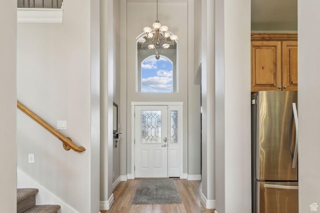 603 S Temple Hill Cir E, Bountiful, UT 84010 - foyer entrance with a chandelier, a high ceiling, stairway, light wood-style flooring, and baseboards