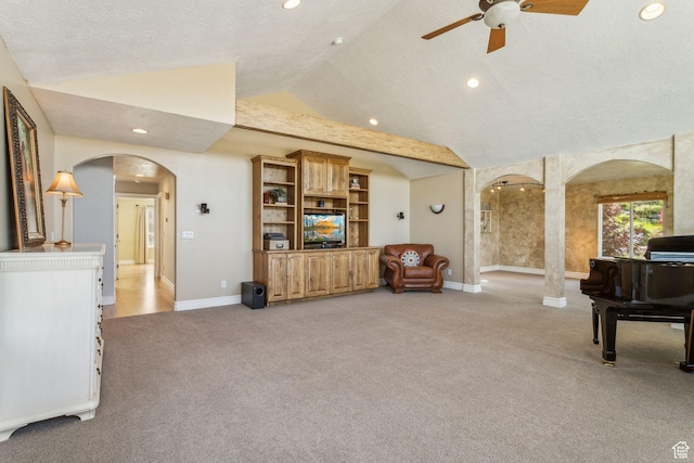 603 S Temple Hill Cir E, Bountiful, UT 84010 - living area featuring arched walkways, vaulted ceiling, light colored carpet, ceiling fan, and baseboards