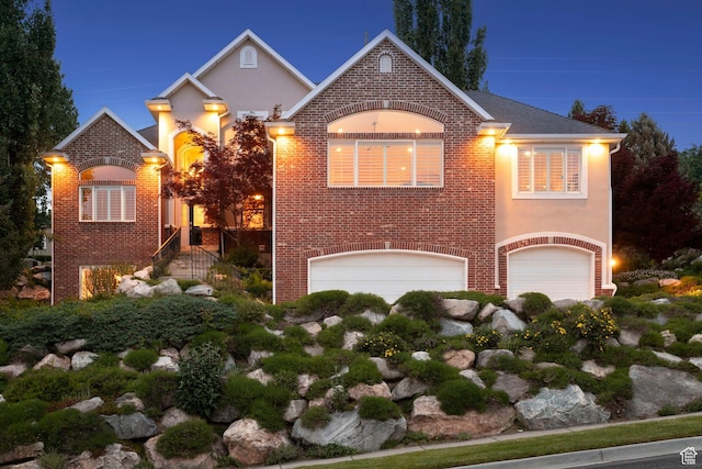 603 S Temple Hill Cir E, Bountiful, UT 84010 - view of front facade with a garage, stucco siding, and brick siding
