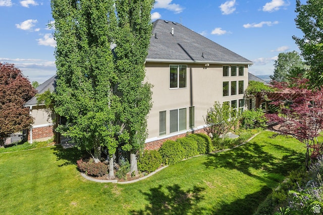 603 S Temple Hill Cir E, Bountiful, UT 84010 - rear view of property featuring a lawn, brick siding, stucco siding, and a shingled roof