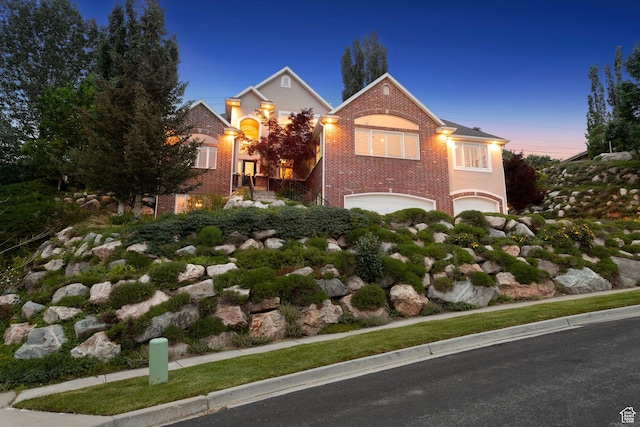 603 S Temple Hill Cir E, Bountiful, UT 84010 - view of front of home with an attached garage, brick siding, and stairs