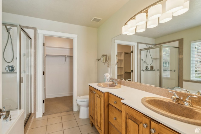 603 S Temple Hill Cir E, Bountiful, UT 84010 - bathroom featuring a stall shower, a walk in closet, double vanity, tile patterned floors, and toilet