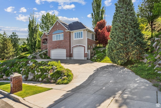 603 S Temple Hill Cir E, Bountiful, UT 84010 - view of front of house featuring driveway, a garage, and brick siding