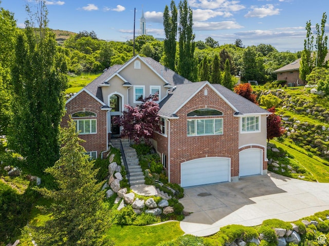 603 S Temple Hill Cir E, Bountiful, UT 84010 - traditional-style house with a garage, concrete driveway, brick siding, and stucco siding