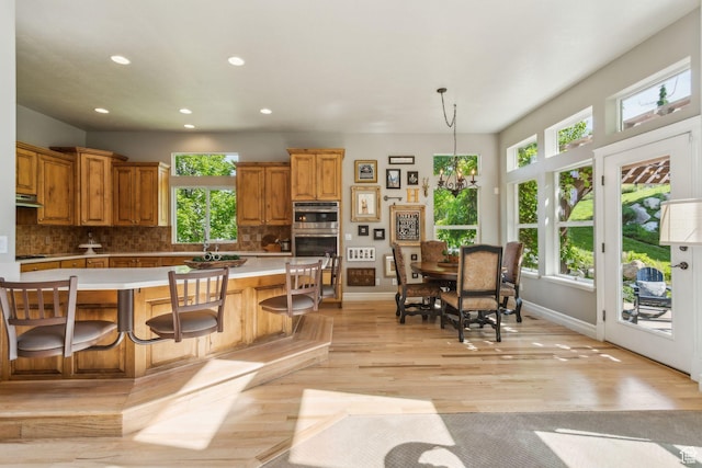 603 S Temple Hill Cir E, Bountiful, UT 84010 - kitchen featuring light countertops, double oven, healthy amount of natural light, backsplash, and recessed lighting
