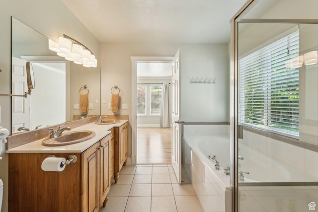 603 S Temple Hill Cir E, Bountiful, UT 84010 - full bathroom featuring a bath, double vanity, tile patterned flooring, and toilet