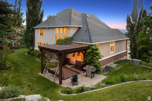 603 S Temple Hill Cir E, Bountiful, UT 84010 - back of property at dusk featuring a patio area, a yard, brick siding, and a pergola