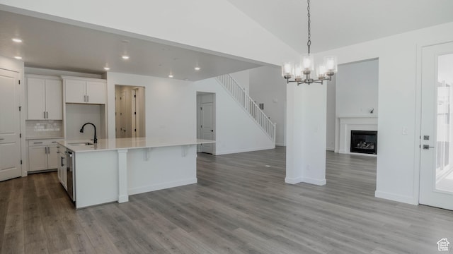 891 W Fallow Dr Unit 211, Saratoga Springs, UT 84045 - kitchen with a chandelier, open floor plan, white cabinets, recessed lighting, and tasteful backsplash