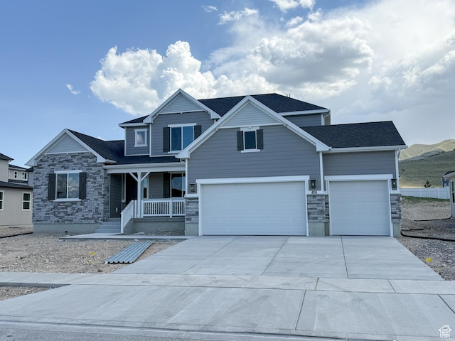 891 W Fallow Dr Unit 211, Saratoga Springs, UT 84045 - craftsman-style home with a porch, stone siding, concrete driveway, an attached garage, and roof with shingles