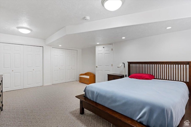 938 E Bernay Cir, Sandy, UT 84094 - bedroom featuring a textured ceiling, carpet floors, two closets, and recessed lighting