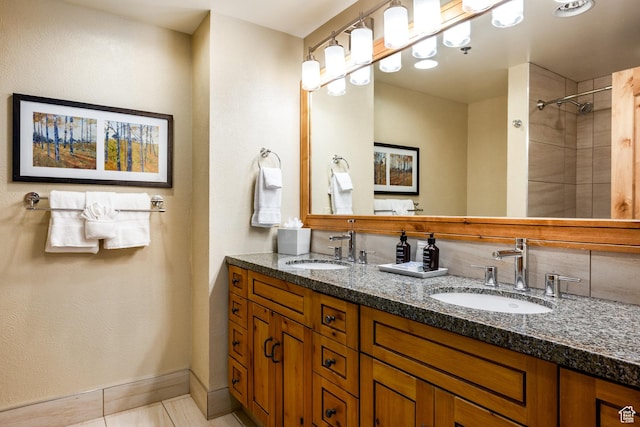 3855 Grand Summit Dr Unit 214Q1, Park City, UT 84098 - bathroom featuring double vanity, tile patterned floors, tiled shower, and baseboards