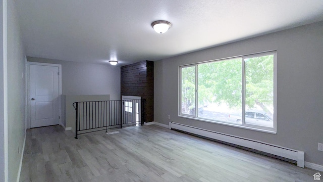 230 S 700 W, Price, UT 84501 - unfurnished room featuring a baseboard heating unit, wood finished floors, and baseboards