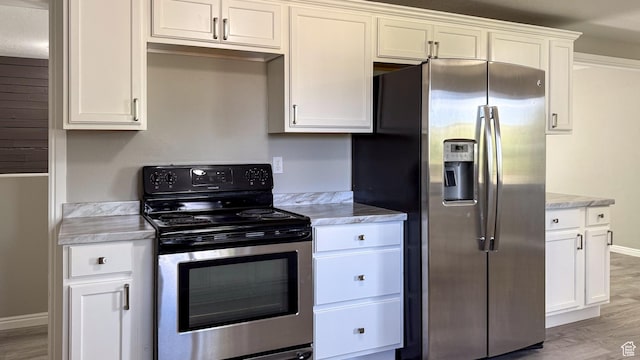 230 S 700 W, Price, UT 84501 - kitchen with appliances with stainless steel finishes, light countertops, light wood-style floors, and white cabinetry