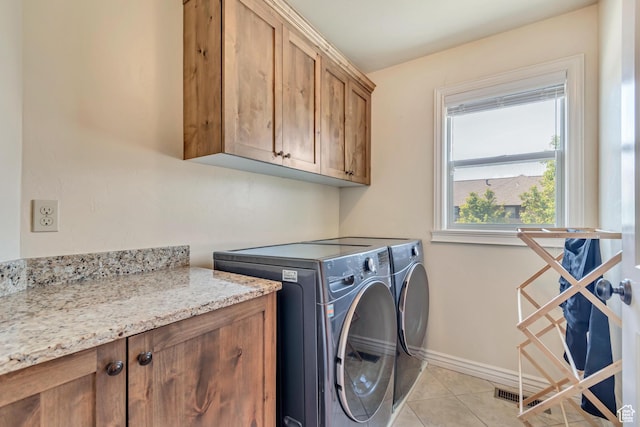7259 S Viansa Ct, Midvale, UT 84047 - laundry area featuring cabinet space, separate washer and dryer, light tile patterned floors, and baseboards