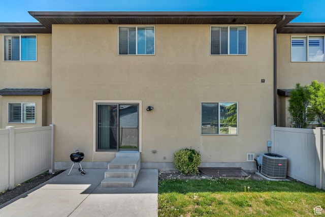 7259 S Viansa Ct, Midvale, UT 84047 - rear view of house featuring a patio area, stucco siding, central AC, and entry steps