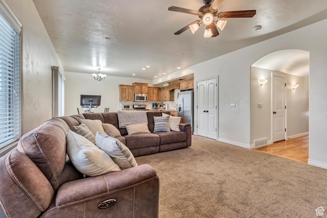 7259 S Viansa Ct, Midvale, UT 84047 - living area with light colored carpet, arched walkways, a ceiling fan, baseboards, and recessed lighting