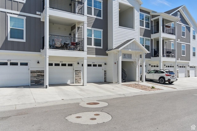 972 W Spider Green Way N Unit E302, Saratoga Springs, UT 84045 - view of front of home featuring board and batten siding, a garage, and driveway