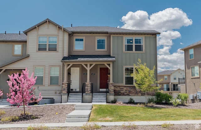 1097 W Wasatch Spring Rd, Kamas, UT 84036 - view of front of house featuring board and batten siding, stone siding, and a front lawn
