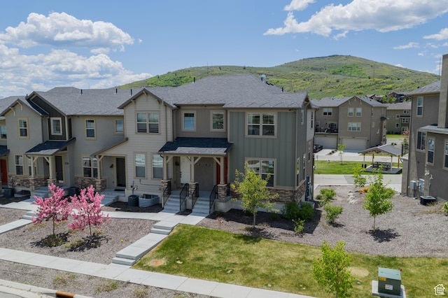 1097 W Wasatch Spring Rd, Kamas, UT 84036 - view of front of home with board and batten siding, a residential view, a mountain view, and stone siding