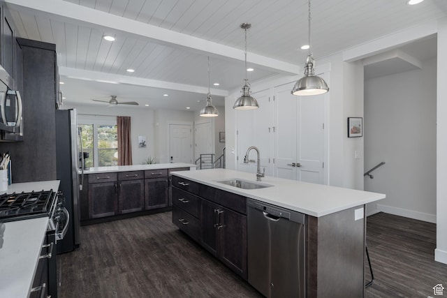 1097 W Wasatch Spring Rd, Kamas, UT 84036 - kitchen featuring appliances with stainless steel finishes, a sink, dark wood finished floors, an island with sink, and light countertops