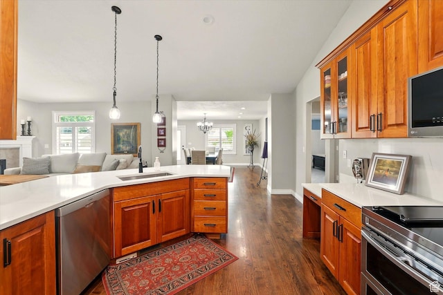 774 W 2300 S, Syracuse, UT 84075 - kitchen with appliances with stainless steel finishes, a sink, open floor plan, dark wood-style floors, and brown cabinetry