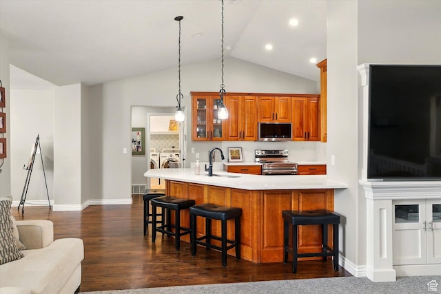 774 W 2300 S, Syracuse, UT 84075 - kitchen with stainless steel appliances, washing machine and clothes dryer, a sink, brown cabinets, and glass insert cabinets